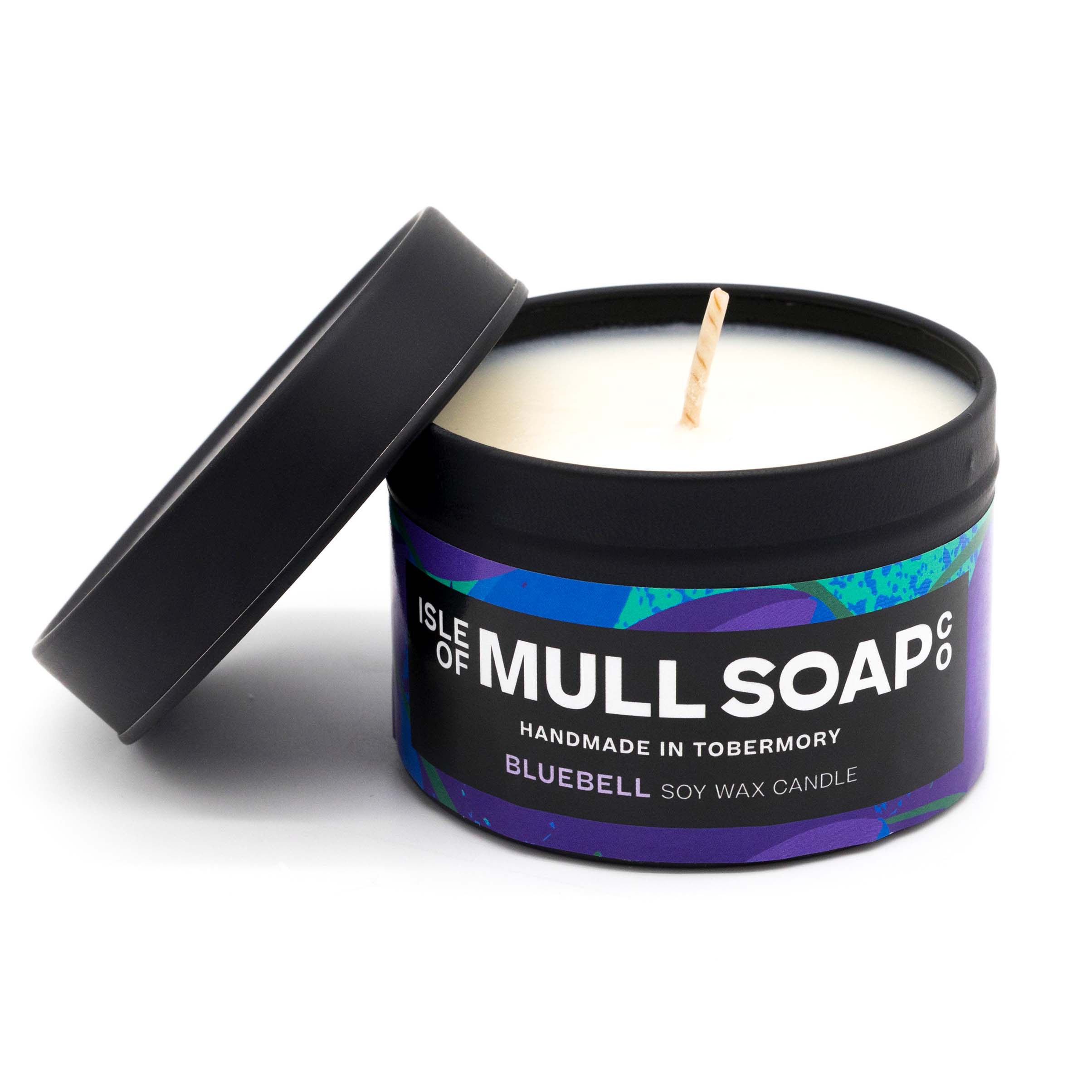 A black tin and lid with blue and purple floral label. bluebell soy wax candle handmade in Tobermory by the Isle of Mull Soap Co 